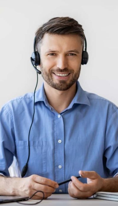 portrait-of-smiling-male-customer-service-operator-2022-12-16-08-34-45-utc-min.jpg
